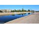 Tranquil canal view with clear water reflecting the buildings and sky at 5100 N Miller Rd # 20, Scottsdale, AZ 85250