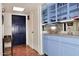 Bright entryway with terracotta tile floor and blue cabinetry at 5100 N Miller Rd # 20, Scottsdale, AZ 85250