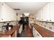 Galley kitchen with butcher block countertops and terracotta tile floors at 5100 N Miller Rd # 20, Scottsdale, AZ 85250