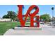 Large red LOVE sculpture in a park-like setting at 5100 N Miller Rd # 20, Scottsdale, AZ 85250