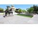 A sunny plaza features a statue and manicured landscaping at 5100 N Miller Rd # 20, Scottsdale, AZ 85250