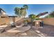 Relaxing backyard patio with fire pit, seating area, and built-in grill at 5227 W Desperado Way, Phoenix, AZ 85083