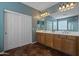 Bathroom with double sinks, large mirror and tiled floor at 5227 W Desperado Way, Phoenix, AZ 85083