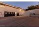 Rear exterior view of the house featuring a large driveway and a multi-car garage at 5655 N Camelback Canyon Dr, Phoenix, AZ 85018