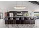 Gourmet kitchen island featuring bar seating and designer lighting at 5655 N Camelback Canyon Dr, Phoenix, AZ 85018