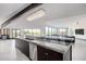 Spacious kitchen island with stone countertop, dark cabinetry, and stainless steel dishwasher at 5655 N Camelback Canyon Dr, Phoenix, AZ 85018