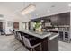 Stylish kitchen island with bar seating and modern lighting at 5655 N Camelback Canyon Dr, Phoenix, AZ 85018