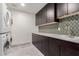 Modern laundry room with sleek cabinetry, modern appliances and designer backsplash at 5655 N Camelback Canyon Dr, Phoenix, AZ 85018