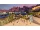 A view from an outdoor dining area with seating and scenic mountain views at 5655 N Camelback Canyon Dr, Phoenix, AZ 85018