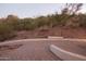 Outdoor patio with brick pavers overlooking natural desert vegetation at 5655 N Camelback Canyon Dr, Phoenix, AZ 85018