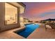 An inviting pool view showcasing poolside lounge chairs with mountain views at dusk at 5655 N Camelback Canyon Dr, Phoenix, AZ 85018