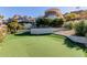 Putting green, mature trees and landscaped area of backyard at 5655 N Camelback Canyon Dr, Phoenix, AZ 85018