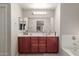 Double vanity bathroom with a large soaking tub at 5856 E Hampton Ave, Mesa, AZ 85206