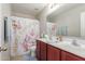 Bathroom with double vanity and a Christmas-themed shower curtain at 5856 E Hampton Ave, Mesa, AZ 85206