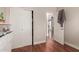 Bedroom with wood flooring, a closet, and view of another room at 5856 E Hampton Ave, Mesa, AZ 85206