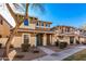 Two story house on a tree lined street with a blue front door at 5856 E Hampton Ave, Mesa, AZ 85206