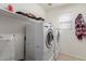 Laundry room with washer, dryer, and shelving for storage at 5856 E Hampton Ave, Mesa, AZ 85206