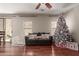 Living room with hardwood floors, Christmas tree and comfortable seating at 5856 E Hampton Ave, Mesa, AZ 85206