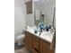 Double sink bathroom with wood vanity and mirror at 603 W Sierra Vista Dr, Apache Junction, AZ 85120