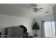 Bright bedroom with ceiling fan and plush headboard at 603 W Sierra Vista Dr, Apache Junction, AZ 85120