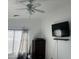 Bedroom with ceiling fan, dresser, and mounted TV at 603 W Sierra Vista Dr, Apache Junction, AZ 85120