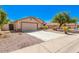 House with a two-car garage and a gated side yard at 603 W Sierra Vista Dr, Apache Junction, AZ 85120