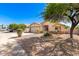 House with a two-car garage and a well-manicured lawn at 603 W Sierra Vista Dr, Apache Junction, AZ 85120