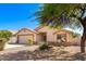 House with a two-car garage and desert landscaping at 603 W Sierra Vista Dr, Apache Junction, AZ 85120