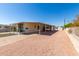 Mobile home exterior with carport and gravel driveway at 630 S 93Rd Pl, Mesa, AZ 85208