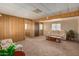 Bright living room featuring wood paneling and comfortable seating at 630 S 93Rd Pl, Mesa, AZ 85208