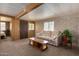 Open living room with wood paneling and view to bedroom at 630 S 93Rd Pl, Mesa, AZ 85208