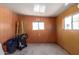 Empty spare room with window and wood paneling at 630 S 93Rd Pl, Mesa, AZ 85208