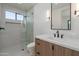 Modern bathroom featuring a glass enclosed shower, a floating vanity, and a decorative mirror at 6614 E North Ln, Paradise Valley, AZ 85253