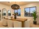 Elegant dining room featuring a wooden table, stylish chairs, modern lighting, and large windows at 6614 E North Ln, Paradise Valley, AZ 85253