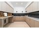 Laundry room with custom cabinets and modern black backsplash at 6614 E North Ln, Paradise Valley, AZ 85253