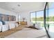 Bright and airy main bedroom with floor to ceiling windows, stylish furnishings, and a private backyard view at 6614 E North Ln, Paradise Valley, AZ 85253