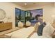 Luxurious main bedroom with a view of the pool, featuring stylish decor and ample natural light at 6614 E North Ln, Paradise Valley, AZ 85253