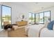 Serene main bedroom with natural light, a cozy sitting area, and a view of the backyard and pool at 6614 E North Ln, Paradise Valley, AZ 85253