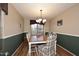 Charming dining room with wood flooring and plaid chairs at 6808 S 36Th Dr, Phoenix, AZ 85041