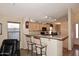 Kitchen with light wood cabinets, granite countertops, and breakfast bar at 6808 S 36Th Dr, Phoenix, AZ 85041