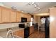 Well-lit kitchen featuring light wood cabinets and black appliances at 6808 S 36Th Dr, Phoenix, AZ 85041