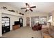 Living room featuring built-in shelving and a ceiling fan at 6808 S 36Th Dr, Phoenix, AZ 85041