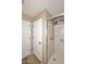 Shower with glass enclosure and built-in shelving at 6808 S 36Th Dr, Phoenix, AZ 85041