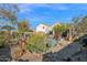 Landscaped backyard with gravel, desert plants, and a bird feeder at 6863 E Haven Ave, Florence, AZ 85132