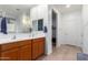 Double vanity bathroom with a walk-in shower and large mirror at 7110 E Gamebird Way, San Tan Valley, AZ 85143