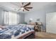 Well-lit bedroom with a king-size bed and ceiling fan at 7110 E Gamebird Way, San Tan Valley, AZ 85143