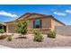 Tan house with stone accents and drought-tolerant landscaping at 7110 E Gamebird Way, San Tan Valley, AZ 85143