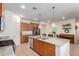 Modern kitchen with granite countertops and wood cabinets at 7110 E Gamebird Way, San Tan Valley, AZ 85143