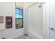 Clean bathroom with a tub shower combo and window at 7275 N Scottsdale Rd # 1001, Paradise Valley, AZ 85253