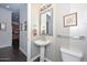 Stylish powder room with pedestal sink and glass shelf at 7275 N Scottsdale Rd # 1001, Paradise Valley, AZ 85253